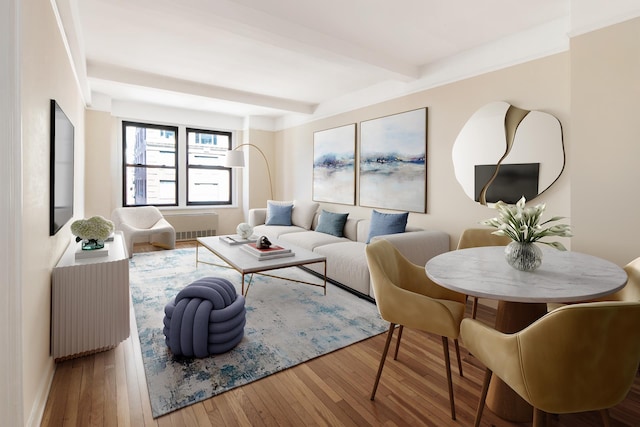 205 E 78th St Unit 14C, New York City, NY 10021 - living area featuring beam ceiling, radiator heating unit, and hardwood / wood-style floors