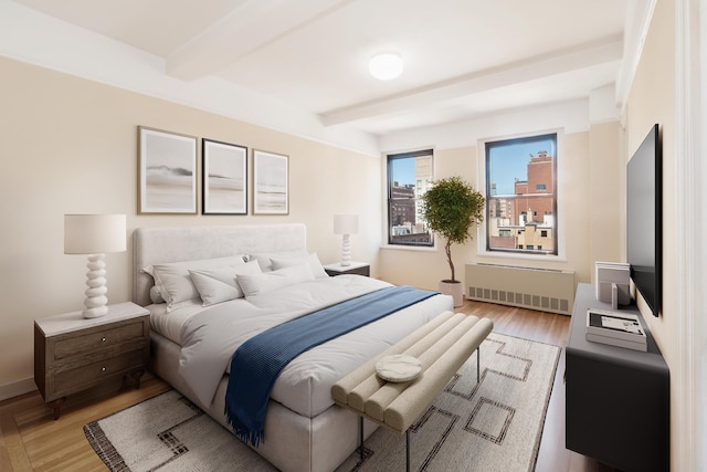 205 E 78th St Unit 14C, New York City, NY 10021 - bedroom featuring radiator heating unit, beamed ceiling, and light wood finished floors