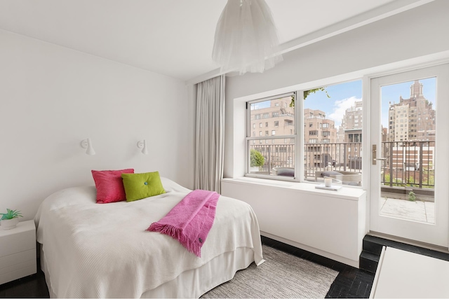 923 5th Ave Unit 12E/11, New York City, NY 10021 - bedroom featuring access to outside, wood finished floors, and a view of city