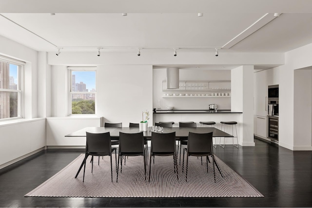 923 5th Ave Unit 12E/11, New York City, NY 10021 - dining area with track lighting, dark wood-type flooring, and wine cooler