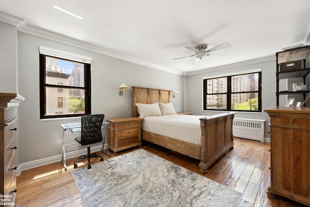 357 E 57th St Unit 3D, New York City, NY 10022 - bedroom with radiator, ornamental molding, hardwood / wood-style floors, and a ceiling fan