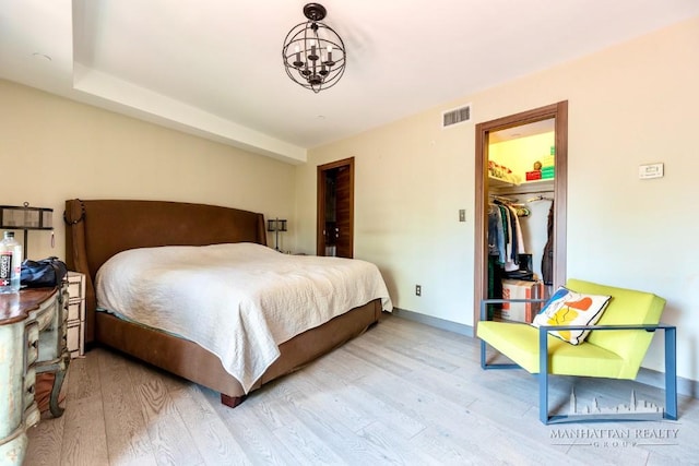 3567 Shore Pkwy Unit 4A, New York City, NY 11235 - bedroom featuring wood finished floors, a chandelier, and a spacious closet