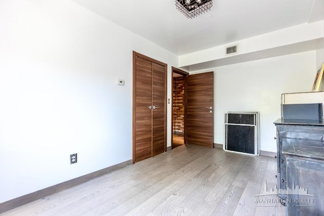 3567 Shore Pkwy Unit 4A, New York City, NY 11235 - unfurnished living room featuring wood finished floors and baseboards