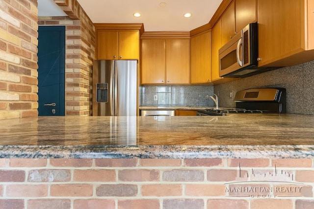 3567 Shore Pkwy Unit 4A, New York City, NY 11235 - kitchen featuring appliances with stainless steel finishes, stone counters, decorative backsplash, and recessed lighting