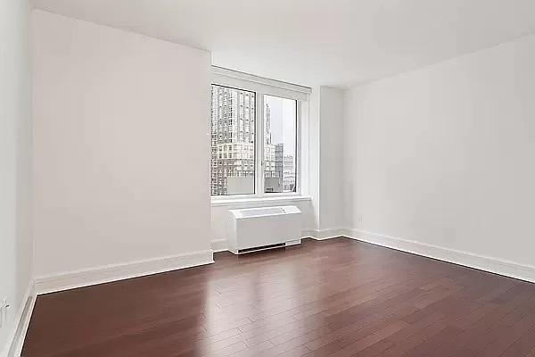 60 Riverside Blvd Unit 1708, New York City, NY 10069 - unfurnished room featuring dark wood-type flooring and radiator