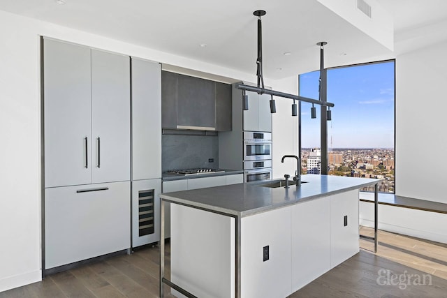 11 Hoyt St Unit 39F, New York City, NY 11201 - kitchen with dark wood-style flooring, beverage cooler, stainless steel appliances, floor to ceiling windows, and modern cabinets