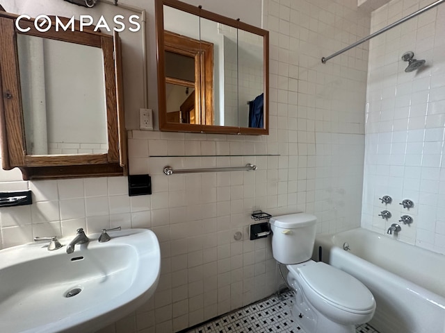 504-510 W 110th St Unit 12E, New York City, NY 10025 - bathroom with tile walls, shower / bathtub combination, and tasteful backsplash