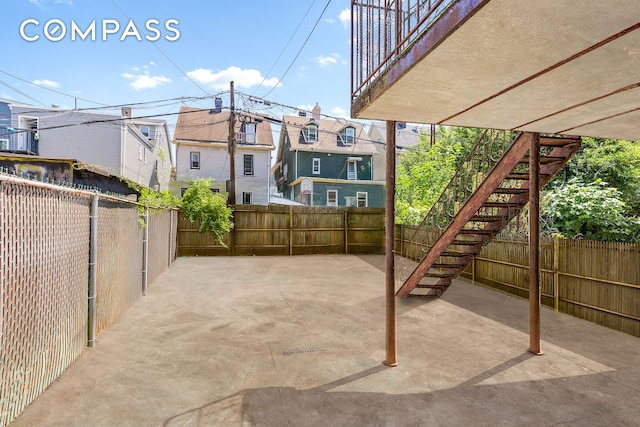 362 Webster Ave, New York City, NY 11230 - fenced backyard with a patio area, a residential view, and stairway