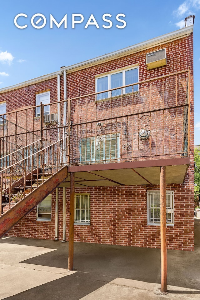 362 Webster Ave, New York City, NY 11230 - rear view of house with brick siding, a carport, and stairway