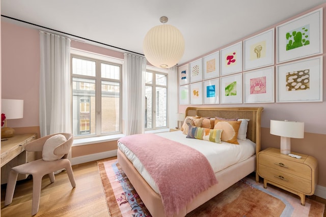 1228 Madison Ave Unit 4, New York City, NY 10128 - bedroom featuring baseboards and light wood finished floors