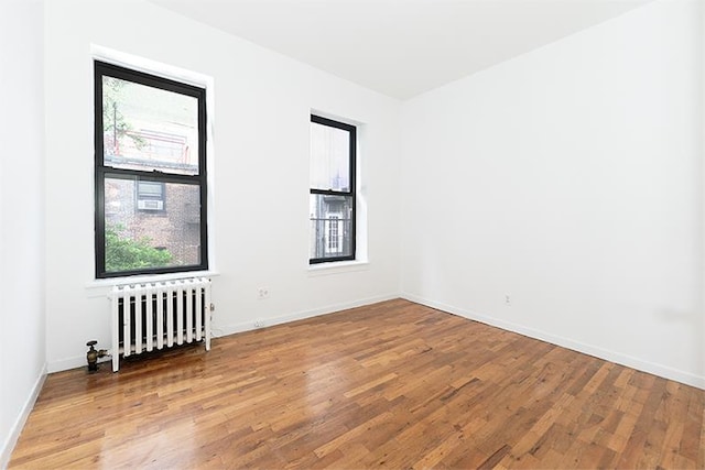 320 W 17th St Unit 4-Re, New York City, NY 10011 - unfurnished room with radiator heating unit and wood finished floors