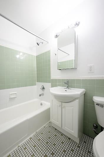 320 W 17th St Unit 4-Re, New York City, NY 10011 - full bathroom featuring tile walls, shower / tub combination, vanity, a wainscoted wall, and tile patterned floors