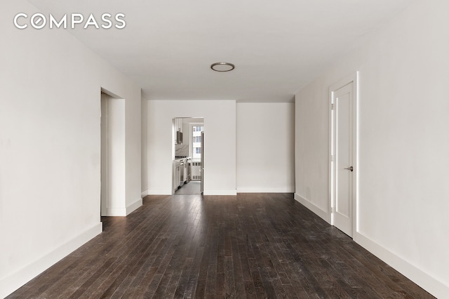 411 E 53rd St Unit 6L, New York City, NY 10022 - unfurnished room featuring dark wood-style flooring and baseboards