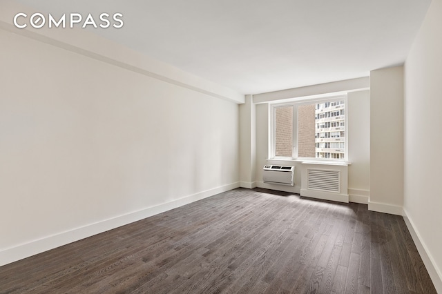 411 E 53rd St Unit 6L, New York City, NY 10022 - spare room with dark wood-style flooring and an AC wall unit