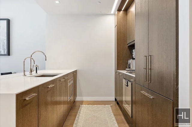 301 E 50th St Unit 5B, New York City, NY 10022 - kitchen featuring modern cabinets, a peninsula, and light countertops