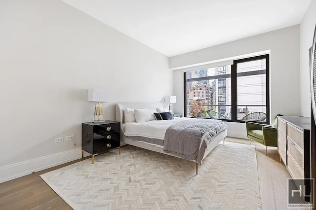 301 E 50th St Unit 5B, New York City, NY 10022 - bedroom with wood finished floors and baseboards