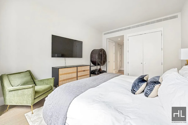 301 E 50th St Unit 5B, New York City, NY 10022 - bedroom with a closet and wood finished floors