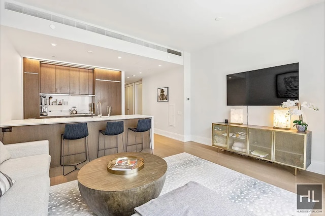 301 E 50th St Unit 5B, New York City, NY 10022 - living area with light wood-style floors and recessed lighting