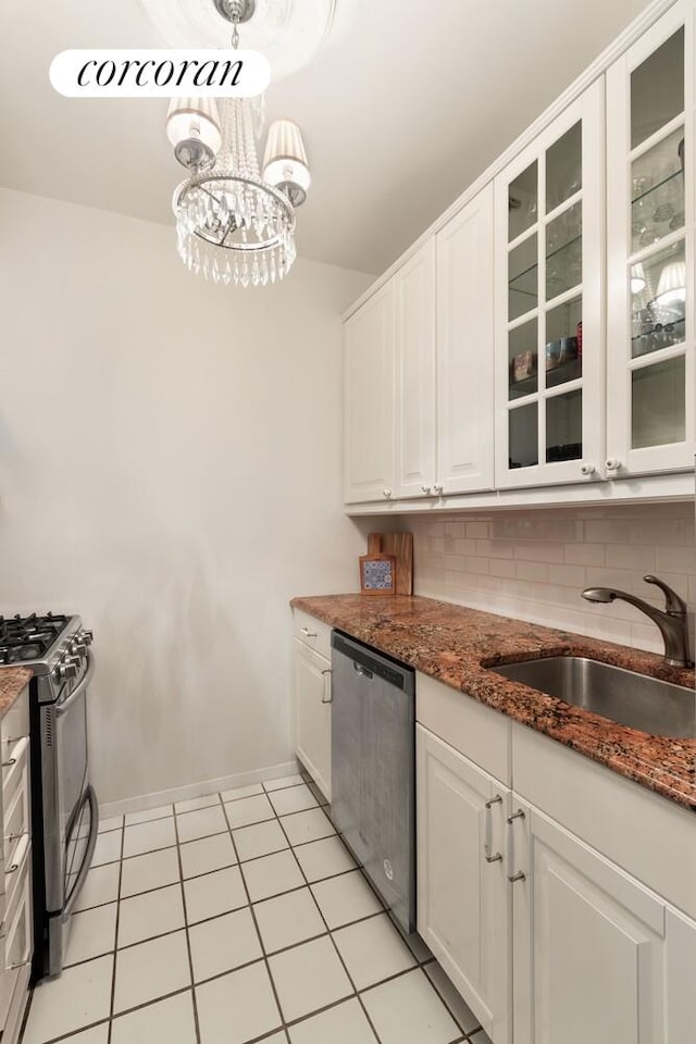 200 E 69th St Unit 2R, New York City, NY 10021 - kitchen with stainless steel appliances, white cabinetry, tasteful backsplash, and glass insert cabinets