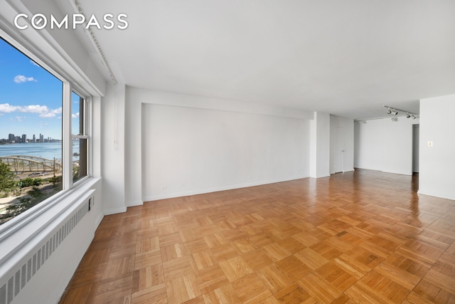 50 Sutton Pl S Unit 5E, New York City, NY 10022 - empty room featuring radiator and a view of city