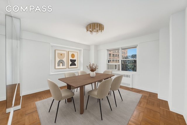 50 Sutton Pl S Unit 5E, New York City, NY 10022 - dining area featuring radiator heating unit and a chandelier