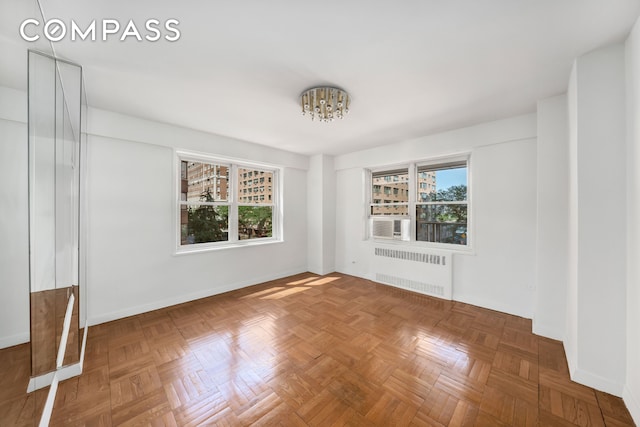 50 Sutton Pl S Unit 5E, New York City, NY 10022 - spare room featuring radiator, a chandelier, and cooling unit