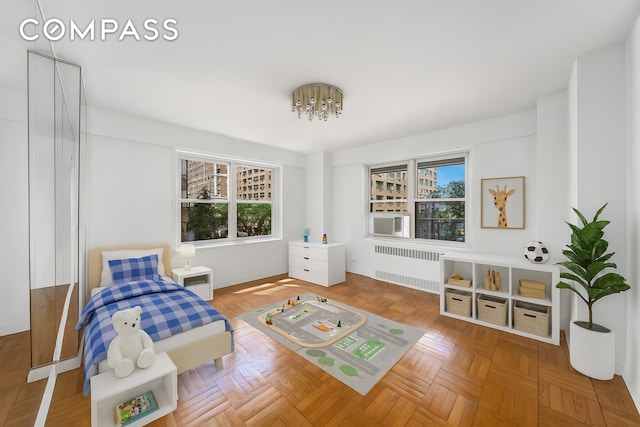 50 Sutton Pl S Unit 5E, New York City, NY 10022 - sitting room featuring radiator, plenty of natural light, a chandelier, and cooling unit