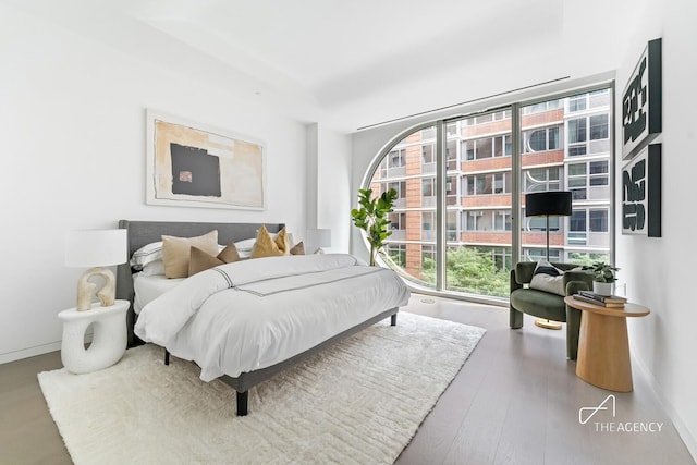 520 W 28th St Unit 7, New York City, NY 10001 - bedroom with wood finished floors and expansive windows
