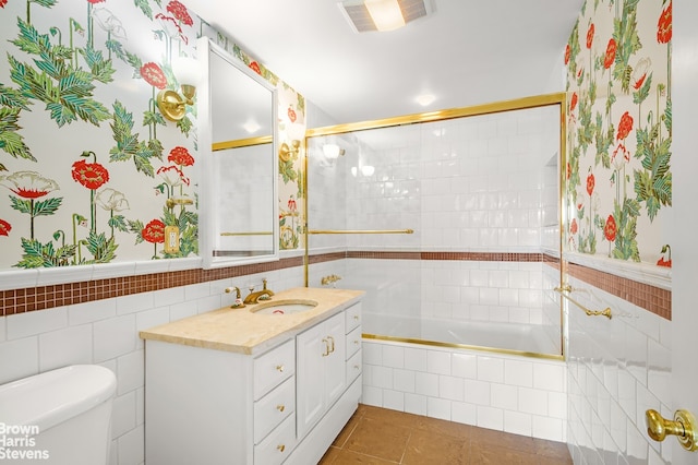 380 W 12th St Unit 6B, New York City, NY 10014 - full bathroom with vanity, tiled shower / bath, tile walls, tile patterned flooring, and wallpapered walls