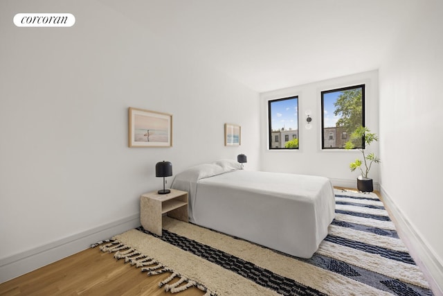 966 Bergen St, New York City, NY 11216 - bedroom with baseboards and wood finished floors