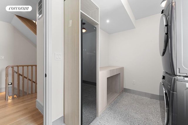 966 Bergen St, New York City, NY 11216 - washroom featuring stacked washing machine and dryer and baseboards