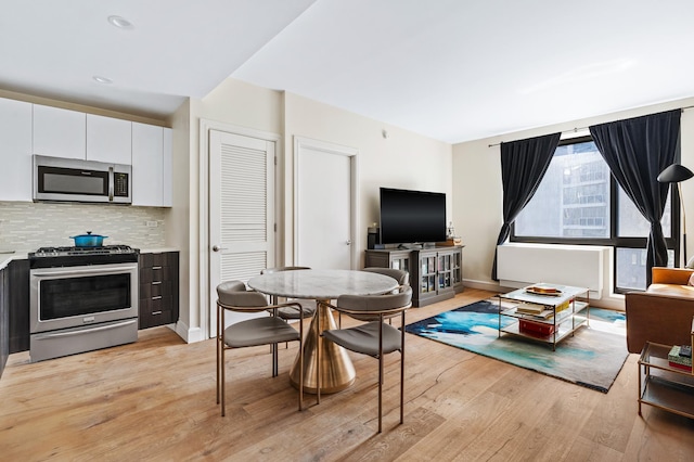 25-21 43rd Ave Unit 511, New York City, NY 11101 - dining space with light wood-style floors