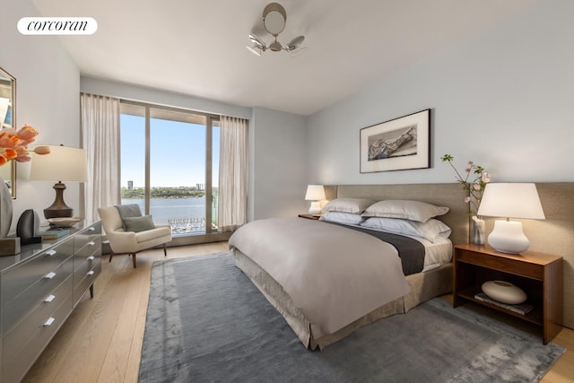 500 W 18th St Unit East18A, New York City, NY 10011 - bedroom featuring wood finished floors, a water view, and access to exterior