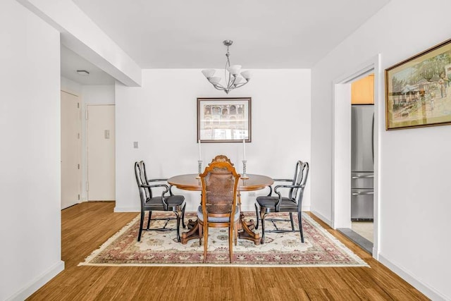 40 E 9th St Unit 9K, New York City, NY 10003 - dining space with a chandelier and wood finished floors