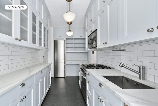 221 W 82nd St Unit 2B, New York City, NY 10024 - kitchen featuring stainless steel appliances, white cabinetry, tasteful backsplash, glass insert cabinets, and pendant lighting