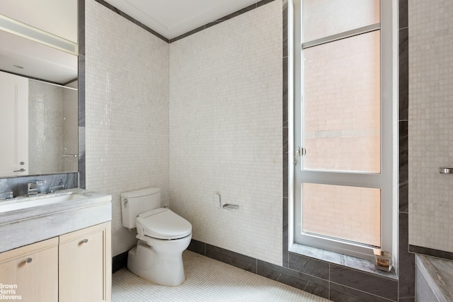200 E 95th St Unit 8C, New York City, NY 10128 - bathroom featuring tile walls, vanity, and tile patterned floors