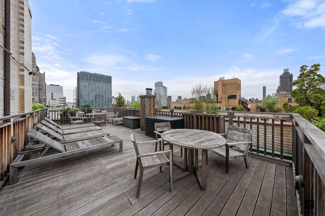 301 E 69th St Unit 12-L, New York City, NY 10021 - wooden deck with outdoor dining space and a view of skyline