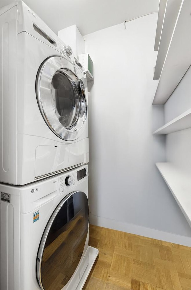 239 E 79th St Unit 9A, New York City, NY 10075 - laundry room with stacked washing machine and dryer and light floors
