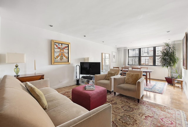 239 E 79th St Unit 9A, New York City, NY 10075 - living area with light wood-type flooring and baseboards