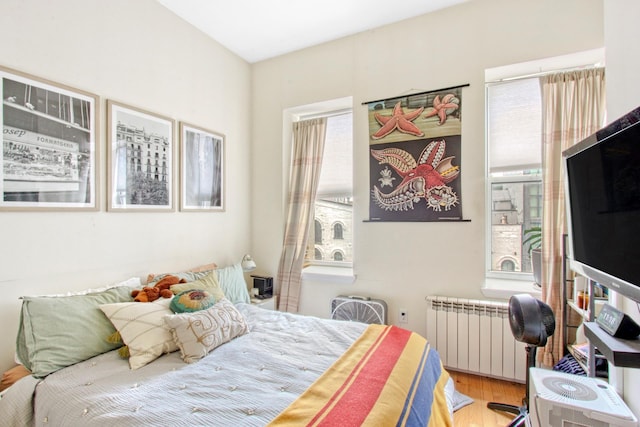 625 Franklin Ave, New York City, NY 11238 - bedroom featuring radiator, multiple windows, and wood finished floors
