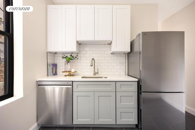 41 Prospect Park SW Unit 1C, New York City, NY 11215 - kitchen featuring appliances with stainless steel finishes, light countertops, tasteful backsplash, and white cabinets