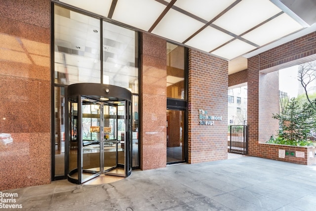 30 W 61st St Unit 23A, New York City, NY 10023 - property entrance featuring brick siding, french doors, and a gate