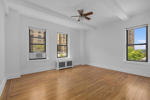 317 W 87th St Unit 7B, New York City, NY 10024 - spare room featuring radiator, cooling unit, a ceiling fan, light wood-style floors, and beamed ceiling