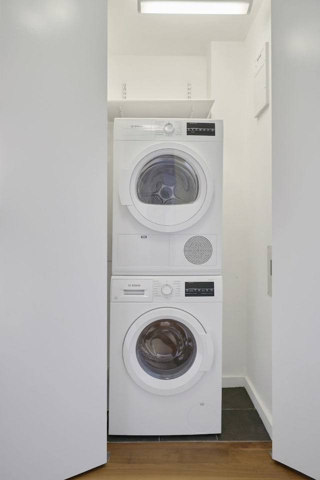 515 E 72nd St Unit 9N, New York City, NY 10021 - laundry room with stacked washing machine and dryer and wood finished floors