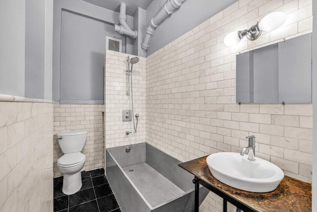 335 W 38th St Unit 11, New York City, NY 10018 - bathroom with tile walls,  shower combination, tile patterned flooring, and pet washing station