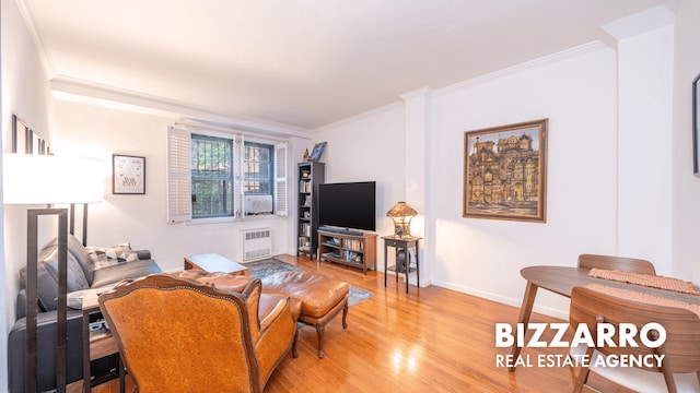 259 Bennett Ave Unit 2F, New York City, NY 10040 - living area featuring radiator, light wood finished floors, and crown molding