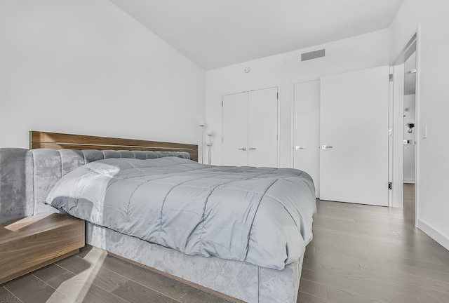 252 S St Unit 73-K, New York City, NY 10002 - bedroom featuring a closet, lofted ceiling, and wood finished floors