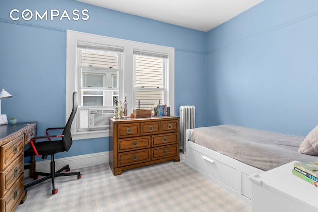 1065 E 39th St, New York City, NY 11210 - carpeted bedroom featuring radiator, cooling unit, and a desk