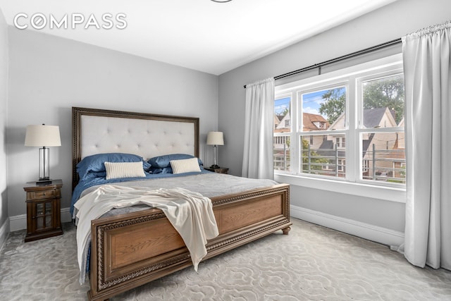 1065 E 39th St, New York City, NY 11210 - bedroom featuring baseboards and carpet