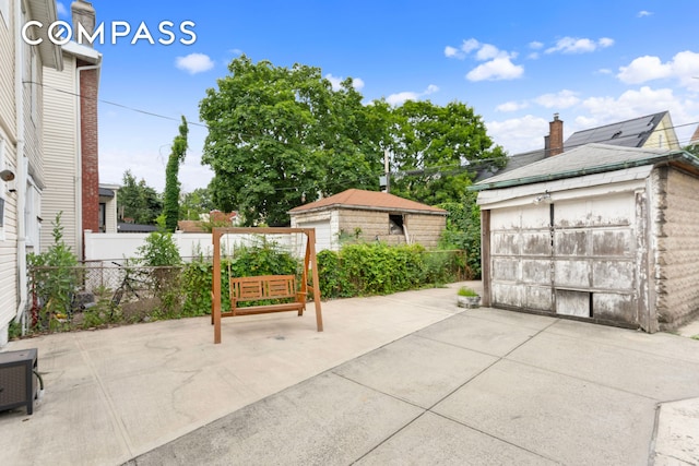 1065 E 39th St, New York City, NY 11210 - view of patio / terrace with an outdoor structure and a detached garage